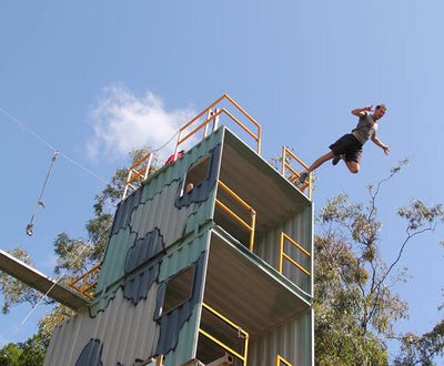 Boy participating in stunt high fall jump from a high tower.
