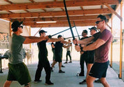 nine people with plastic swords preparing for battle. 